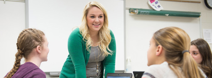 teacher showing an interest in three students