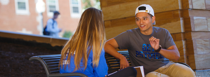 studnets talking on bench